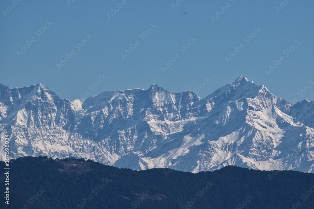 snow covered himalayan mountain peaks in winter