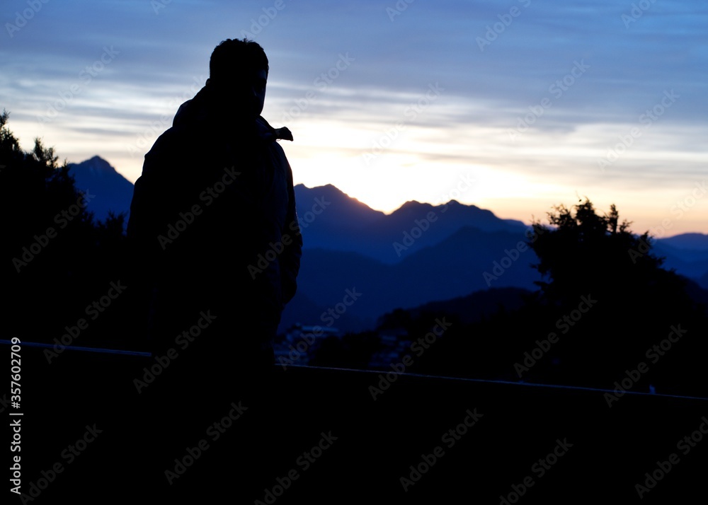 silhouette of a man on the top of mountain