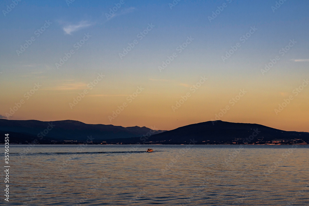 Pleasure boat floating in the bay during a summer sunset. Pleasure boat floating in the bay during a summer sunset.