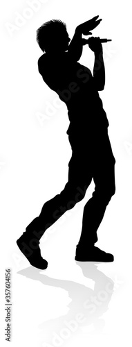 A singer pop, country music, rock star or hiphop rapper artist vocalist singing in silhouette