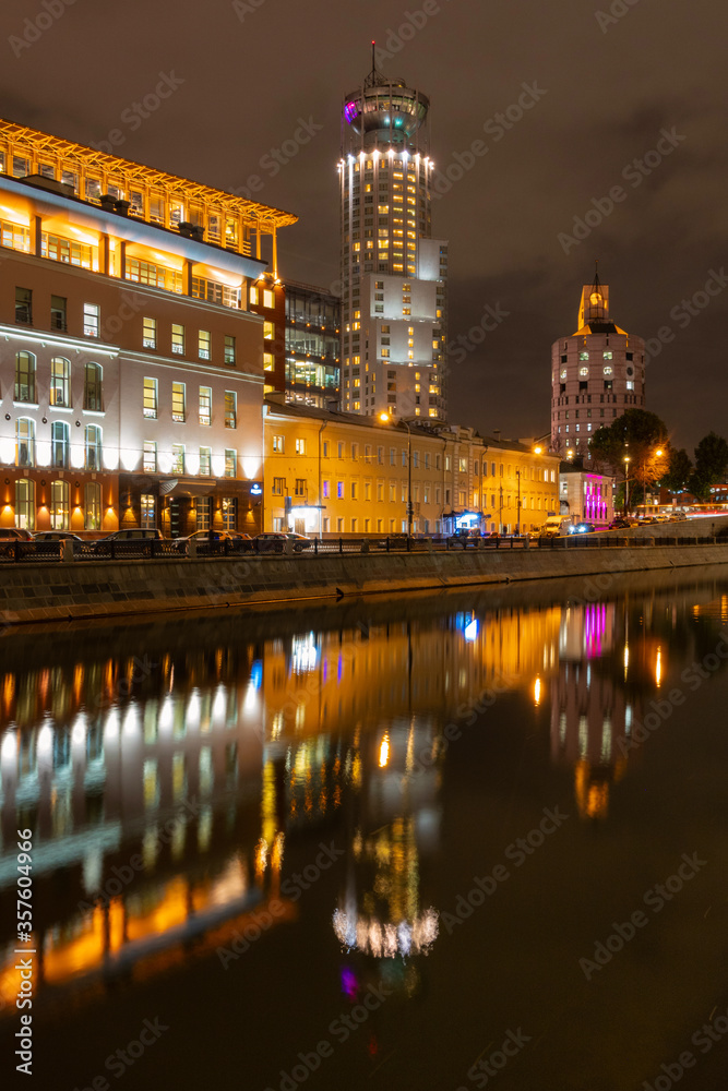 Night city lights on the background of the river with reflections