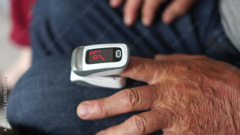 Pulse oximeter on the hand of an elderly man. Monitoring the level of oxygen in the blood of a