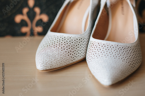 white wedding shoes on the table