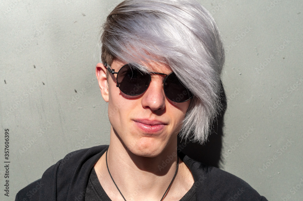 Portrait of young adult with sunglasses, outdoors and with silver-tinted hair. Portrait of young adult with sunglasses, outdoors and with silver-tinted hair.