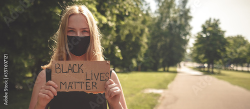 Black Lives Matter protest against the end of racism. Poster on violation of human rights. A white teenager holds a poster with the inscription protest against racism, anti-racism, equality. photo