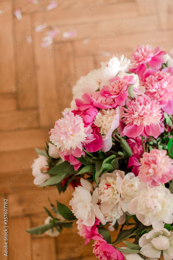 bouquets of peonies on wooden background