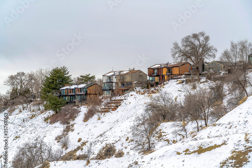 Homes on a mountain setting against cloudy sky in winter at Salt Lake City