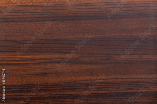 Walnut timber texture. Sanded smooth surface. Brown  red  and black background.