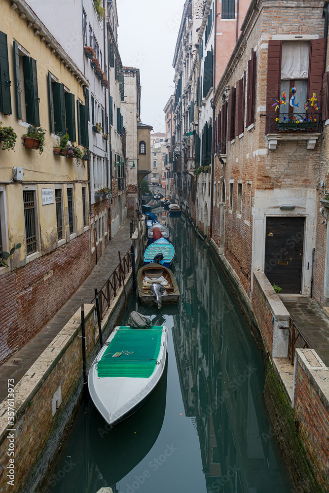 Narrow canal with boats parked ready for tourists.