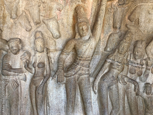 Bas relief rock cut sculptures of gods, people and animals are carved prominently in the monolithic cave temples at Mahabalipuram, Tamil nadu, India photo