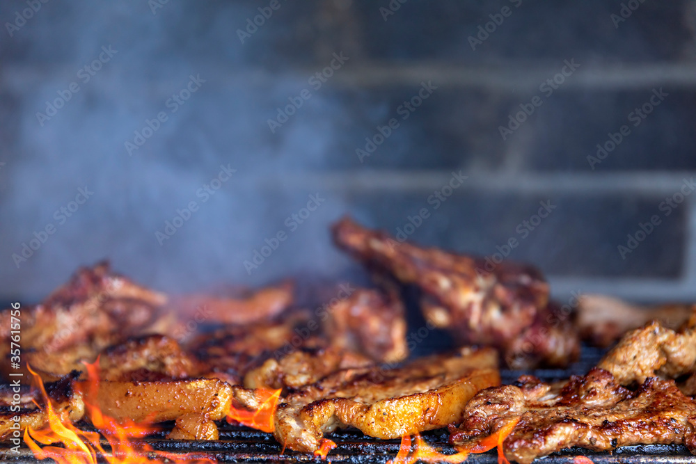 Meat on the barbecue grill, beef steak in smoke from fire