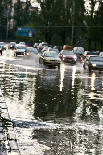 The water drains into the sewer. Flood on the roadway after heavy rain. A lot of cars drive slowly, which would not drown out. Congestion on the road.