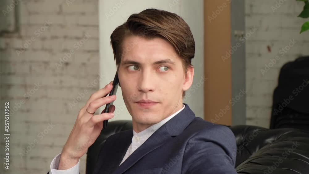 Businessman talking on mobile phone in board room Businessman talking on mobile phone in board room