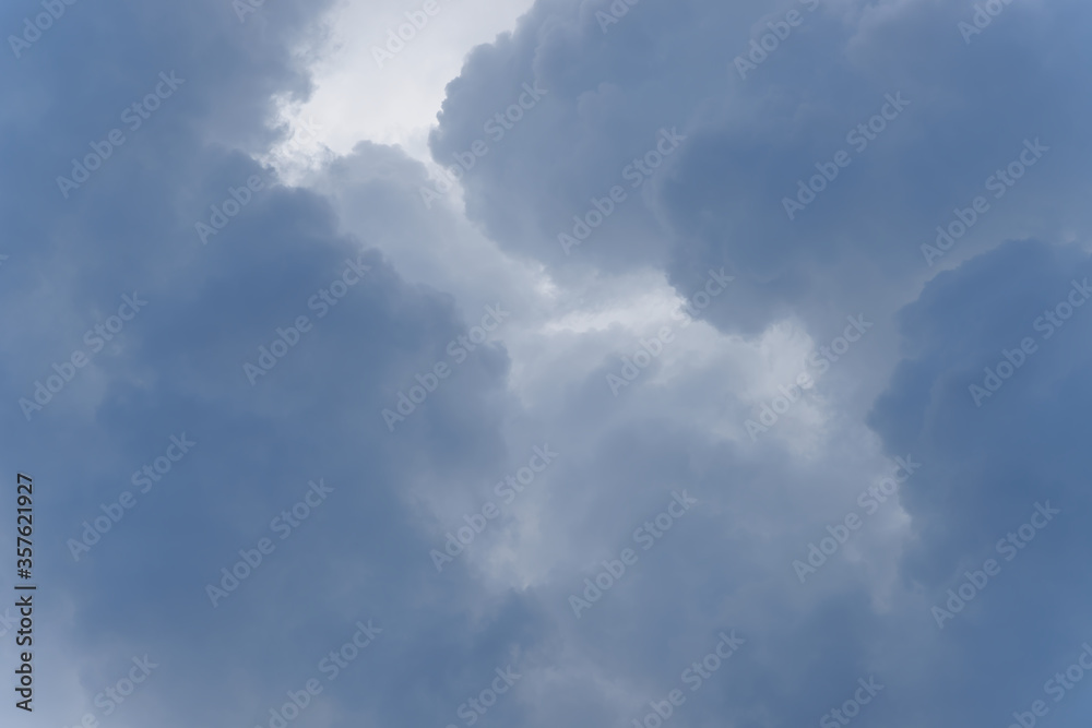 Stormy rain big fluffy clouds. Dark sky. Natural scenic abstract background. Weather changes backdrop. Sky filled with voluminous clouds. Stormy rain big fluffy clouds. Dark sky. Natural scenic abstract background. Weather changes backdrop. Sky filled with voluminous clouds.