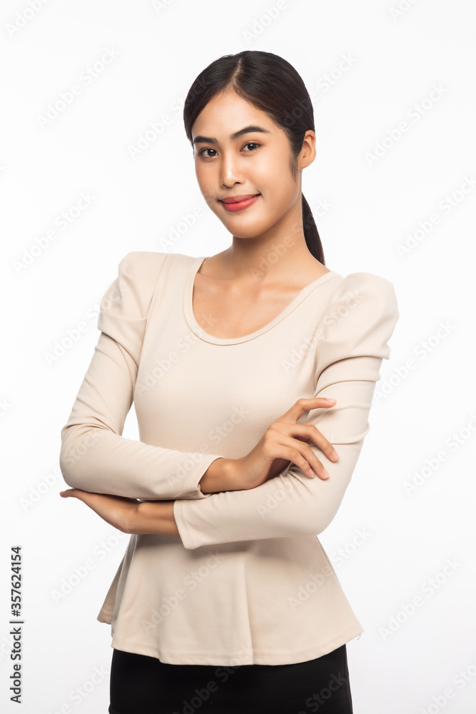 Portrait of young asian business woman standing with arms crossed and looking at camera isolated on white background. Portrait of young asian business woman standing with arms crossed and looking at camera isolated on white background.
