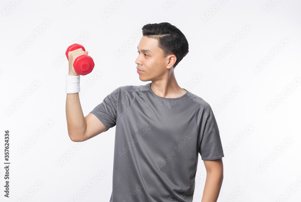 Young handsome asian man in sport outfits exercising with dumbbell isolated on white background. Young handsome asian man in sport outfits exercising with dumbbell isolated on white background.