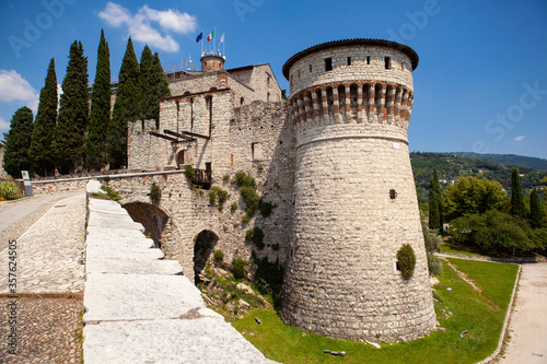 A medieval fortress (castle) with watchtowers, a trench and a walk-in bridge in front of the entrance made of white stones (bricks) in the center of the Italian city of Brescia (Lombardy, Italy).