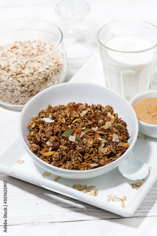 homemade chocolate granola, peanut butter and milk, vertical homemade chocolate granola, peanut butter and milk, vertical