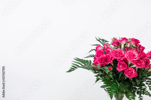 Bouquet of pink flowers on white background and space