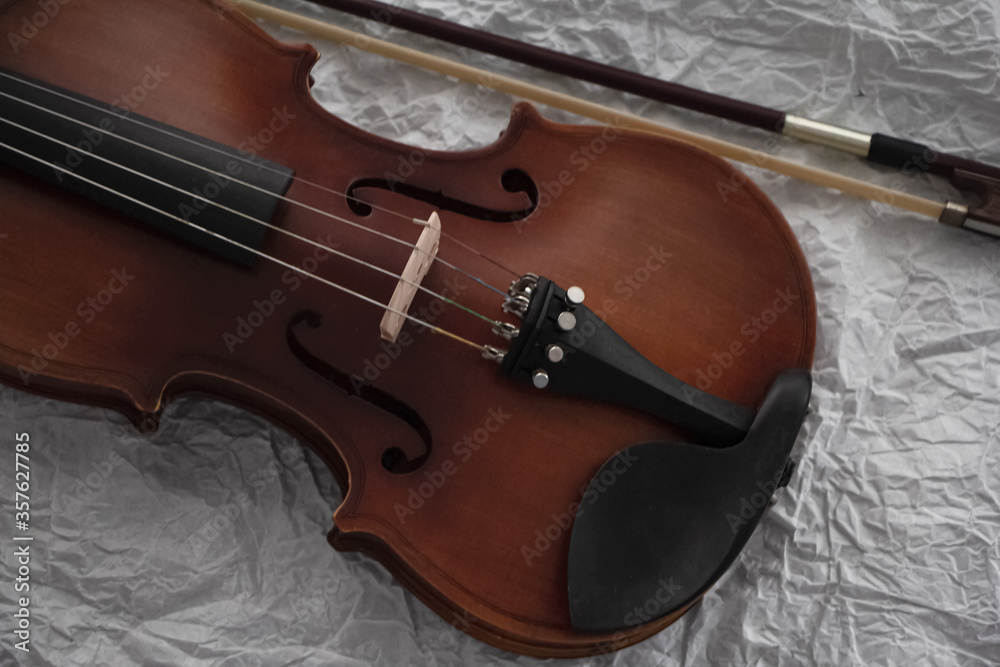 Front side of violin put on background,blurry light around Front side of violin put on background,blurry light around