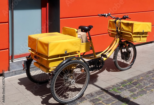 Yellow bicycle of a post man or a post woman to carry out letters and parcels