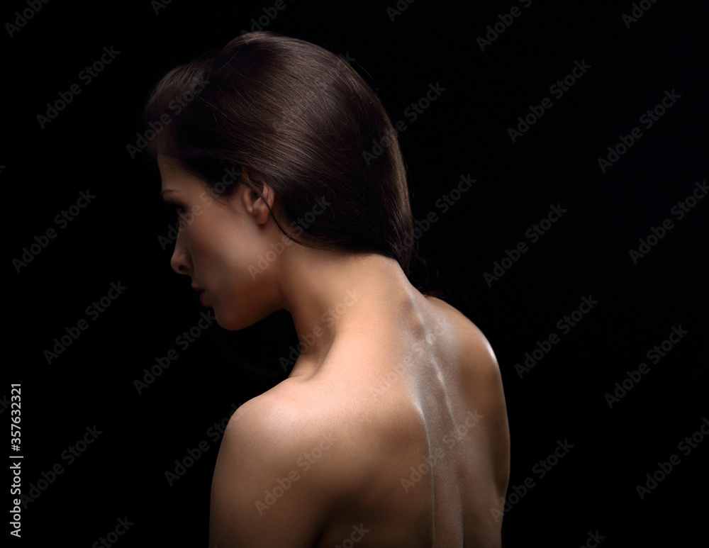 Beautiful sexy woman with nude healthy back and health skin, spine, neck isolated on black background with empty copy space. Closeup profile view studio portrait. Art. Beautiful sexy woman with nude healthy back and health skin, spine, neck isolated on black background with empty copy space. Closeup profile view studio portrait. Art.