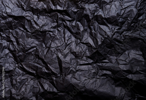 Abstract black paper wrinkled background. 