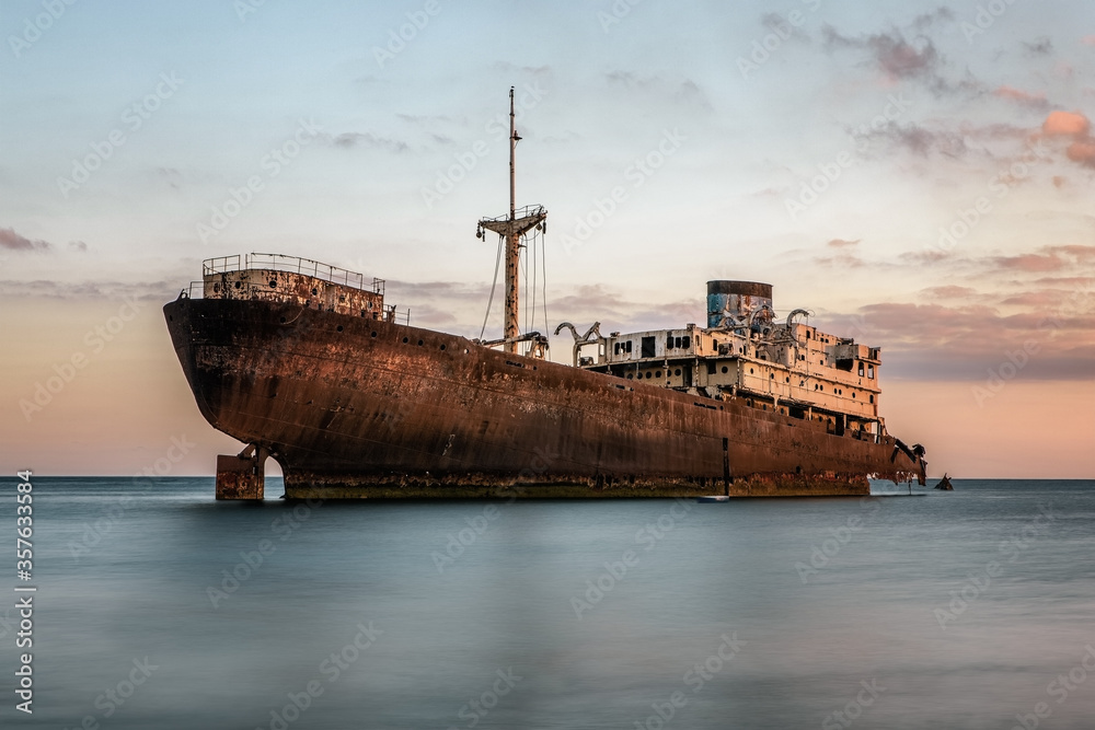 Shipwreck at the sunset on a Lanzarote coast with copy space