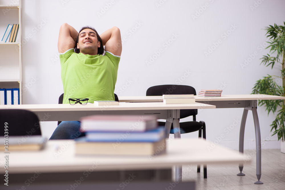 Young male student in the classroom Young male student in the classroom