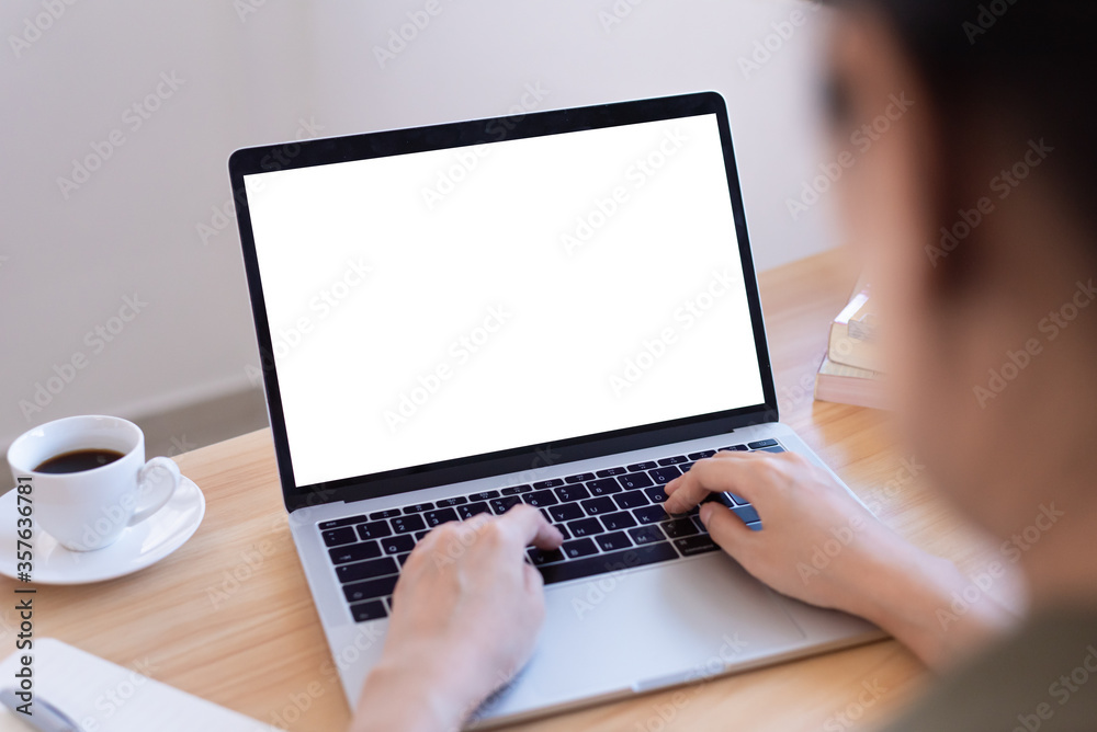 Back side of Asian woman working from home with a blank screen and close-up view. Back side of Asian woman working from home with a blank screen and close-up view.