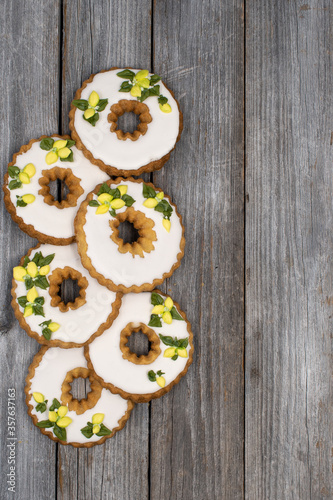 Lemon wreath cookies decorated with royal icing on wooden backgrond