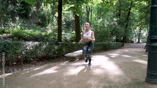 Wallpaper Mural Young pretty girl running in a park outdoors on a summer day under the rays of the sun. Slow motion video. Torontodigital.ca