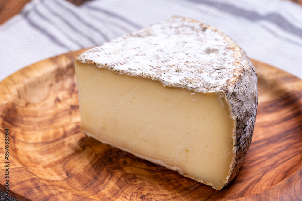 Cheese tomme de montagne or tomme de savoie made from cow milk in French Alps.