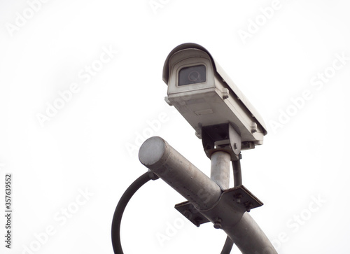 Old CCTV security camera on a high pole for public protection. Surveillance CCTV in the city on White background.