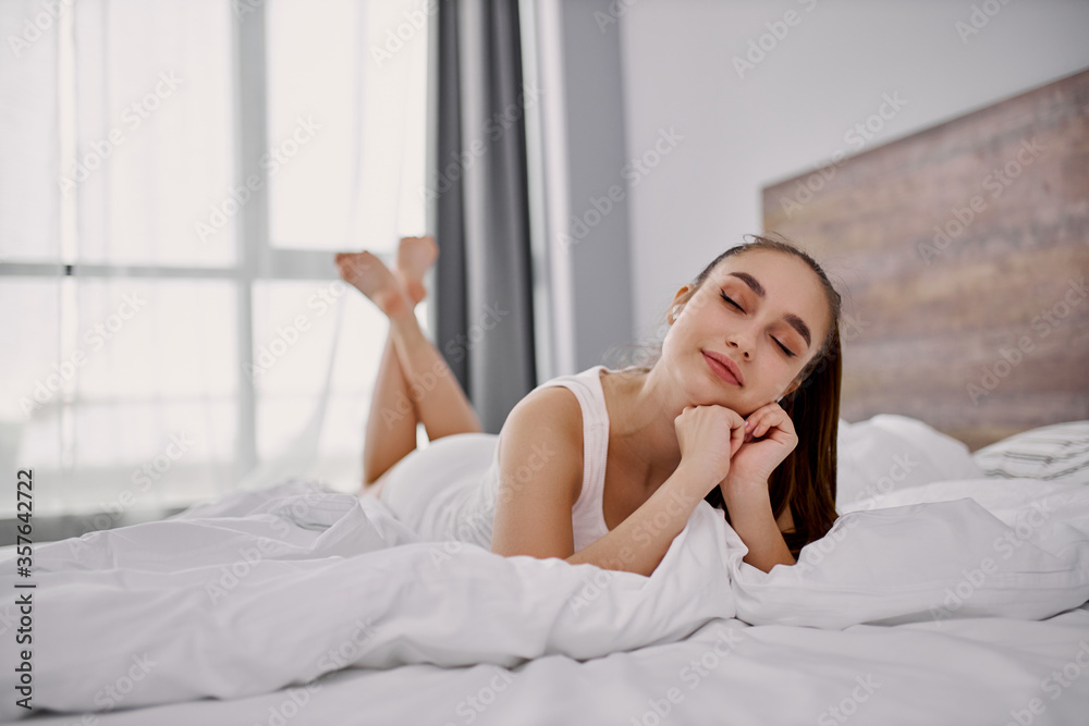 adorable pretty young woman lie on bed, relax in the morning. she has holidays or weekends, spend time at home. adorable pretty young woman lie on bed, relax in the morning. she has holidays or weekends, spend time at home.