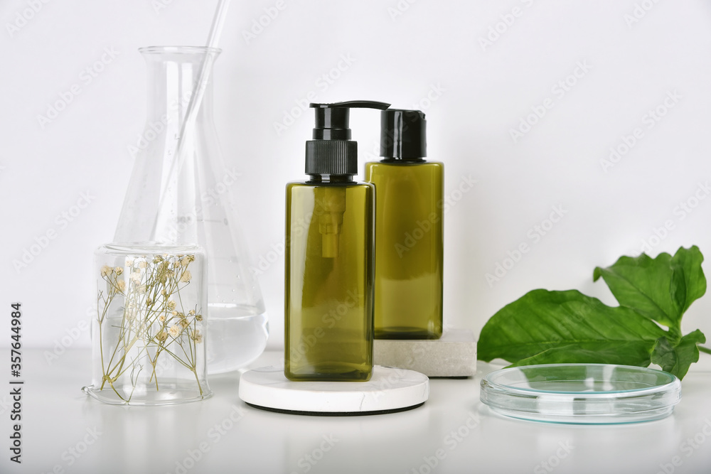 Natural skincare beauty products researching lab, Natural organic botany extraction and scientific laboratory glassware, Blank label cosmetic container for branding mock-up.