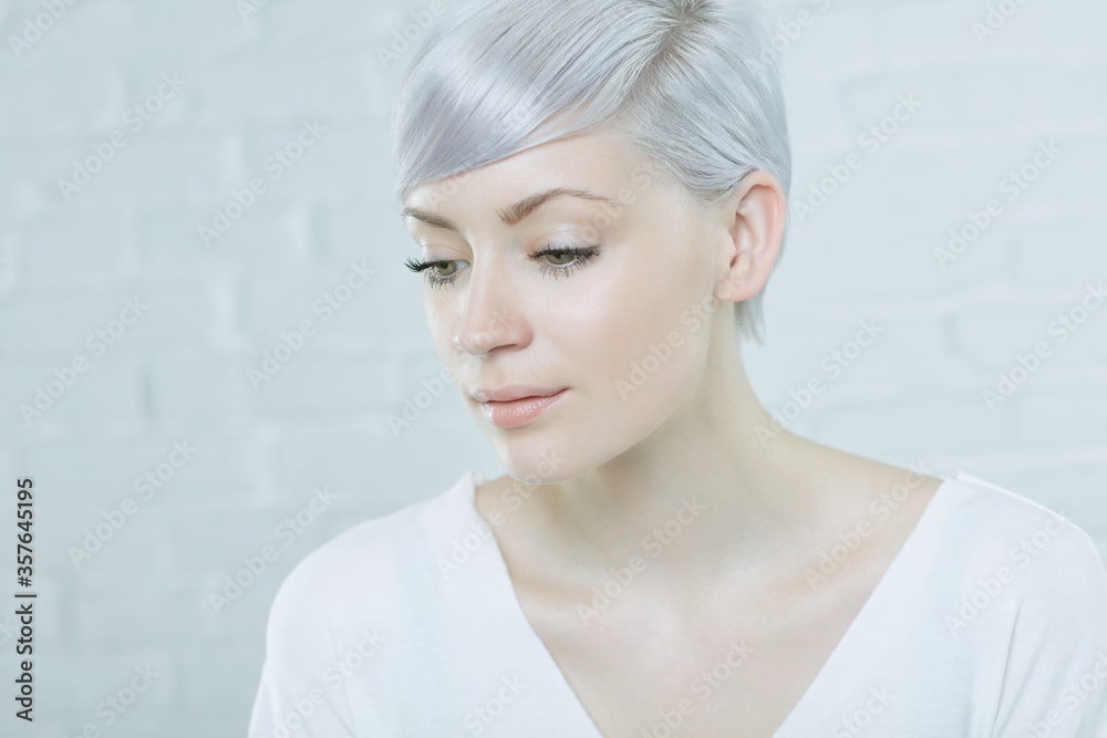 Fototapeta premium Closeup portrait of daydreaming young woman with short hair.