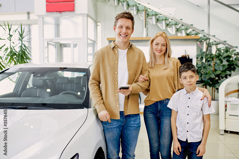 young caucasian family with child happy after getting keys from their new car in dealership, successful purchase without credit. cars, automobile, dealership concept young caucasian family with child happy after getting keys from their new car in dealership, successful purchase without credit. cars, automobile, dealership concept