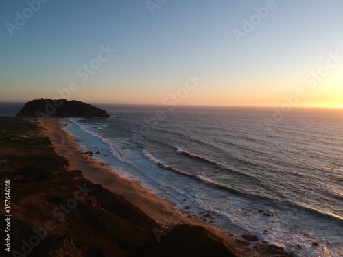Aerial view over Pacific Coast Highway at sunset. Pacific ocean. USA