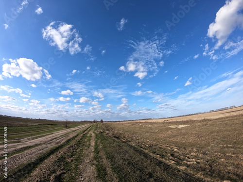 Blue sky with white clouds over farmland. Landscape.