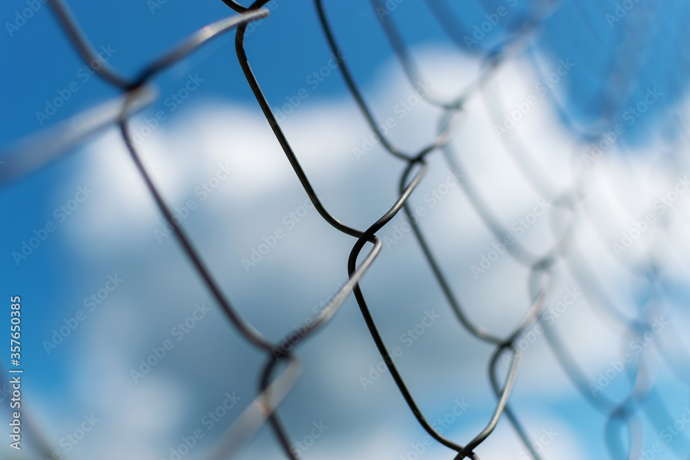 Metal fence close-up. The territory of the fence, against the sky. Metal fence close-up. The territory of the fence, against the sky.