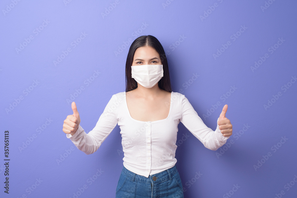 portrait of young woman is wearing face mask on purple background portrait of young woman is wearing face mask on purple background