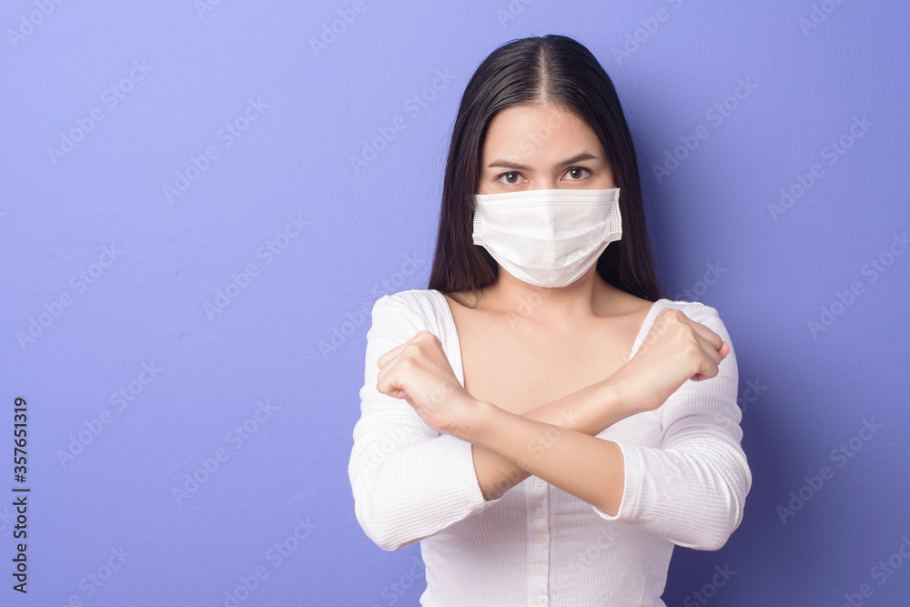 portrait of young woman is wearing face mask on purple background portrait of young woman is wearing face mask on purple background