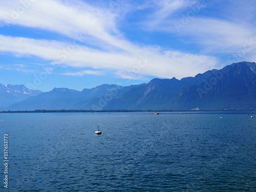 Landscapes of Lake Geneva in european Montreux city in canton Vaud in Switzerland, cloudy blue sky in 2017 warm sunny summer day on July. © Jakub Korczyk