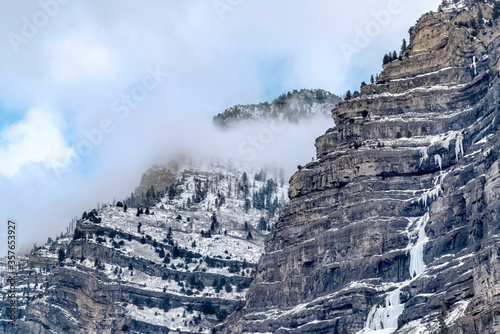 Scenic Provo Canyon scenery with Bridal Veil Falls under sky with thick clouds