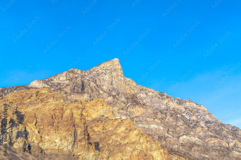 Steep peak and rocky slopes of a mountain in Provo Canyon Utah on a sunny day