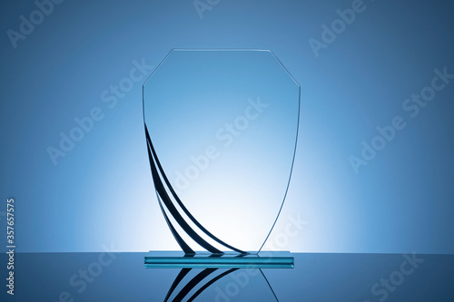 Elegant blank glass shield trophy on dark blue