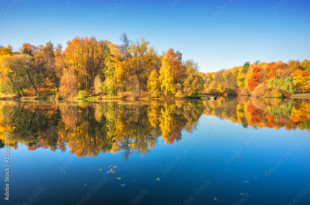Colorful autumn trees in Tsaritsyno park in Moscow with mirror reflection Colorful autumn trees in Tsaritsyno park in Moscow with mirror reflection