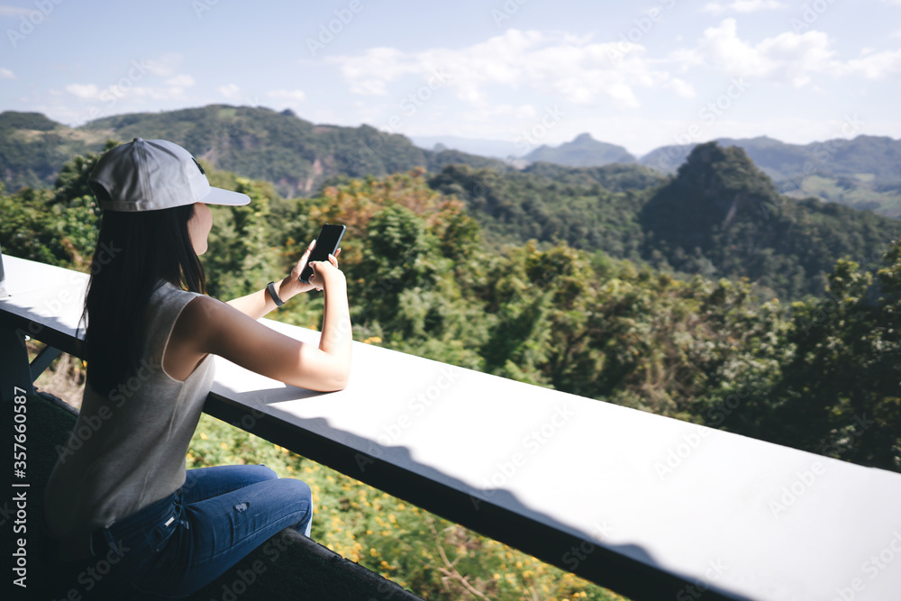 Traveller asian woman use smart phone nature mountain view.