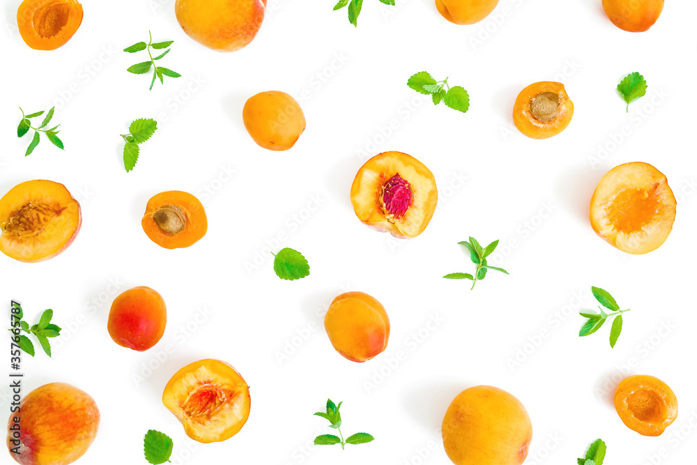 Fruit pattern of ripe apricot and peaches with leaves on white background. Flat lay Fruit pattern of ripe apricot and peaches with leaves on white background. Flat lay